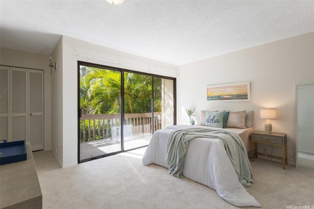 1630 Kalaniiki St Unit 31, Honolulu, HI 96821 - carpeted bedroom featuring access to exterior and a textured ceiling