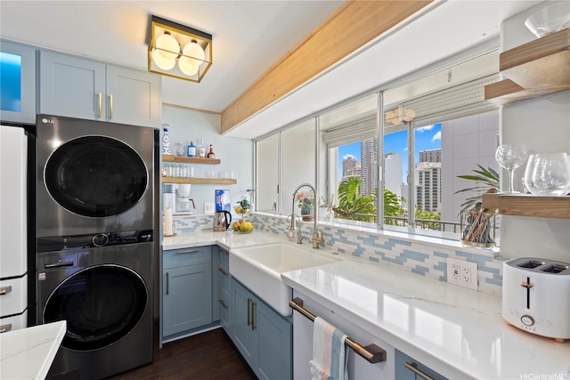 419 Keoniana St Unit 1003, Honolulu, HI 96815 - clothes washing area featuring stacked washer / drying machine, a sink, dark wood finished floors, and a city view