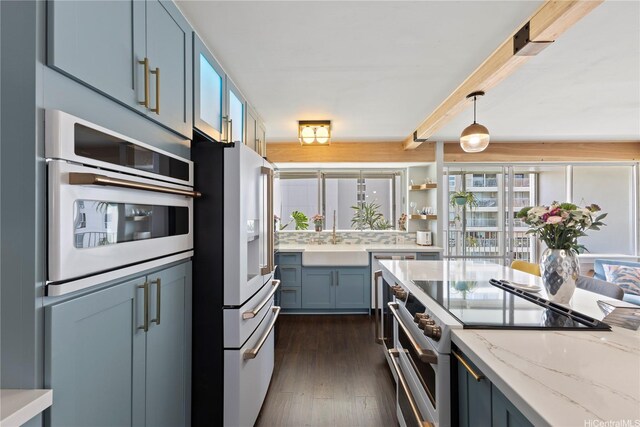 419 Keoniana St Unit 1003, Honolulu, HI 96815 - kitchen featuring high end appliances, dark wood-style floors, light stone counters, pendant lighting, and a sink