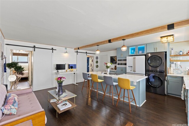 419 Keoniana St Unit 1003, Honolulu, HI 96815 - kitchen featuring stacked washer / dryer, a barn door, high end white refrigerator, light countertops, and dark wood-type flooring