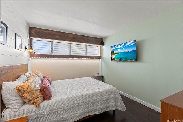419 Keoniana St Unit 1003, Honolulu, HI 96815 - bedroom with baseboards, wood finished floors, and multiple windows