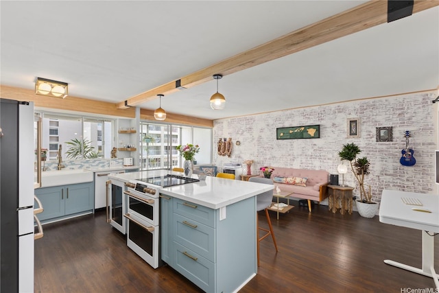 419 Keoniana St Unit 1003, Honolulu, HI 96815 - kitchen with a sink, freestanding refrigerator, range with two ovens, light countertops, and a breakfast bar area