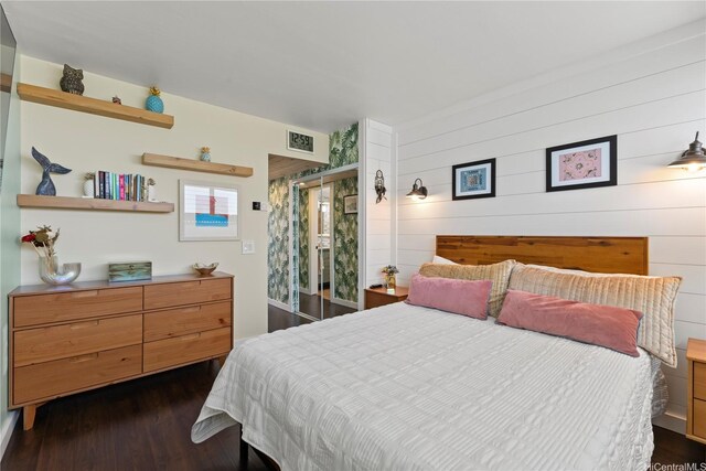 419 Keoniana St Unit 1003, Honolulu, HI 96815 - bedroom with dark wood finished floors and wooden walls