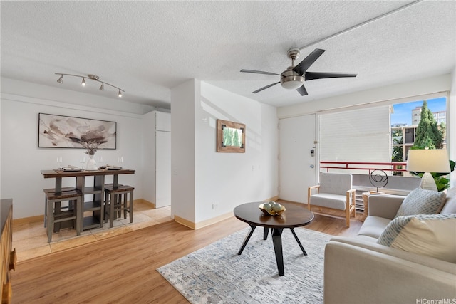 1670 Kalakaua Ave Unit 205, Honolulu, HI 96826 - living room featuring wood finished floors, a textured ceiling, and ceiling fan