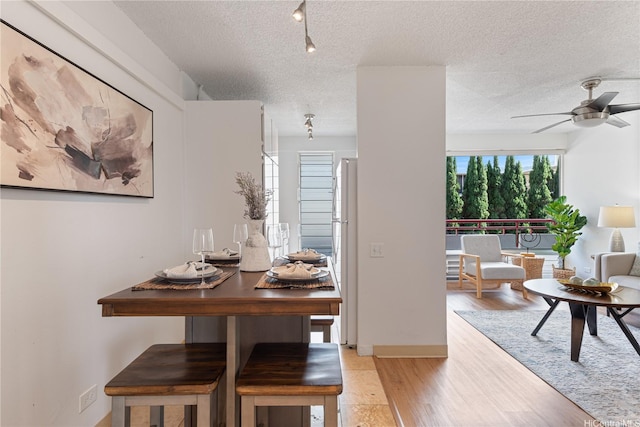 1670 Kalakaua Ave Unit 205, Honolulu, HI 96826 - dining space featuring light wood-style floors, a textured ceiling, and ceiling fan