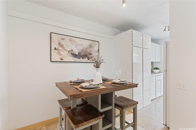 1670 Kalakaua Ave Unit 205, Honolulu, HI 96826 - dining room with a textured ceiling and light tile patterned floors