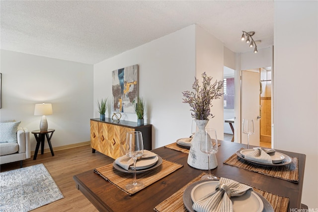 1670 Kalakaua Ave Unit 205, Honolulu, HI 96826 - dining room with a textured ceiling and wood finished floors