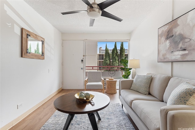 1670 Kalakaua Ave Unit 205, Honolulu, HI 96826 - living room with a textured ceiling, a ceiling fan, and wood finished floors