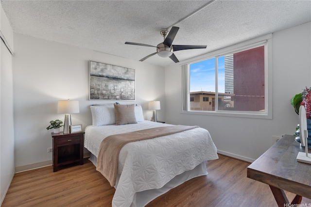 1670 Kalakaua Ave Unit 205, Honolulu, HI 96826 - bedroom with a textured ceiling, wood finished floors, and ceiling fan