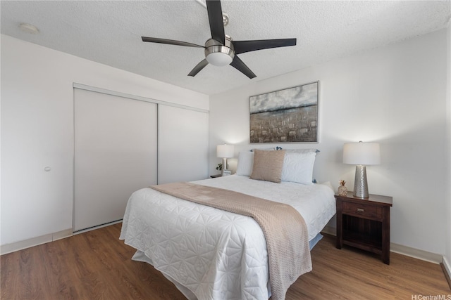 1670 Kalakaua Ave Unit 205, Honolulu, HI 96826 - bedroom with a closet, wood finished floors, a textured ceiling, and ceiling fan