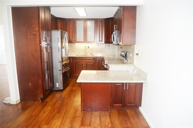 98-524 Lulu Pl Unit 84, Aiea, HI 96701 - kitchen featuring appliances with stainless steel finishes, a peninsula, dark wood finished floors, glass insert cabinets, and light stone counters