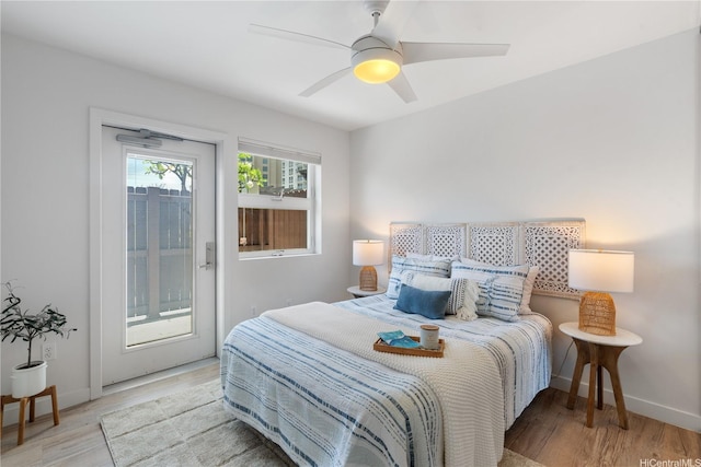 1310 Pensacola St Unit 106, Honolulu, HI 96814 - bedroom with access to outside, wood finished floors, and baseboards