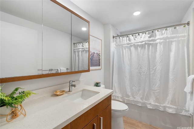 1310 Pensacola St Unit 106, Honolulu, HI 96814 - bathroom with vanity, wood finished floors, toilet, recessed lighting, and shower / bath combo with shower curtain