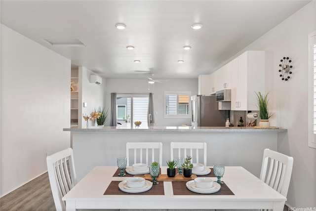 91-1785 Kohanahana Loop, Ewa Beach, HI 96706 - dining area with wood finished floors, a wall mounted AC, a ceiling fan, and recessed lighting
