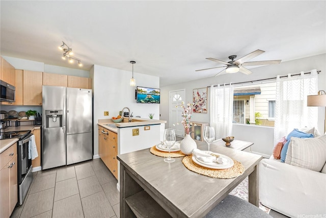 91-1026 Laulauna St Unit 10A, Ewa Beach, HI 96706 - kitchen with appliances with stainless steel finishes, ceiling fan, light brown cabinets, and light countertops
