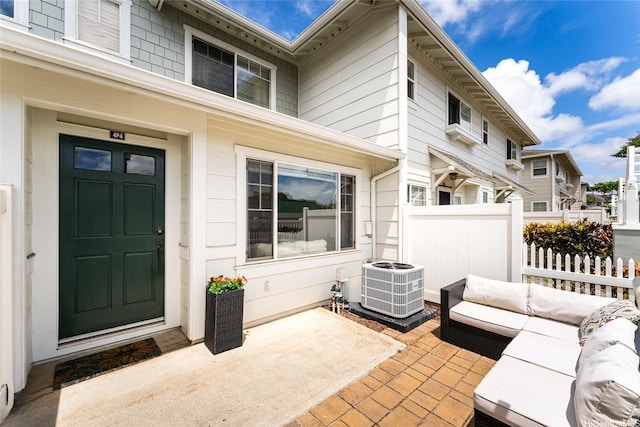 91-1031 Kaimalie St Unit 4P4, Ewa Beach, HI 96706 - property entrance with central air condition unit, an outdoor hangout area, and a patio area