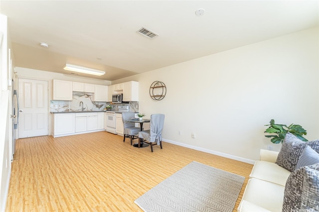 91-1031 Kaimalie St Unit 4P4, Ewa Beach, HI 96706 - home office with light wood-style floors, baseboards, and a sink
