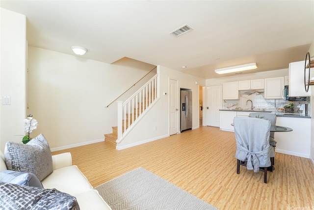 91-1031 Kaimalie St Unit 4P4, Ewa Beach, HI 96706 - living area featuring light wood-style flooring, stairs, and baseboards