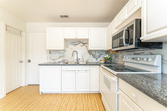 91-1031 Kaimalie St Unit 4P4, Ewa Beach, HI 96706 - kitchen featuring electric range, a sink, stainless steel microwave, white cabinetry, and light wood-style floors