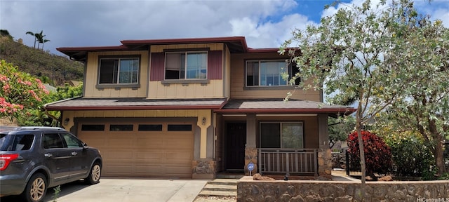 92-1366PUNAWAINUIST Punawainui St, Kapolei, HI 96707 - view of front of home featuring a garage, driveway, board and batten siding, a porch, and stone siding