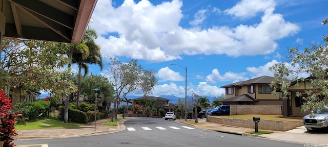 92-1366PUNAWAINUIST Punawainui St, Kapolei, HI 96707 - view of asphalt road featuring street lights, sidewalks, curbs, and a residential view