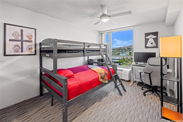 7000 Hawaii Kai Dr Unit 2702, Honolulu, HI 96825 - carpeted bedroom featuring a textured ceiling, expansive windows, a ceiling fan, and an office area