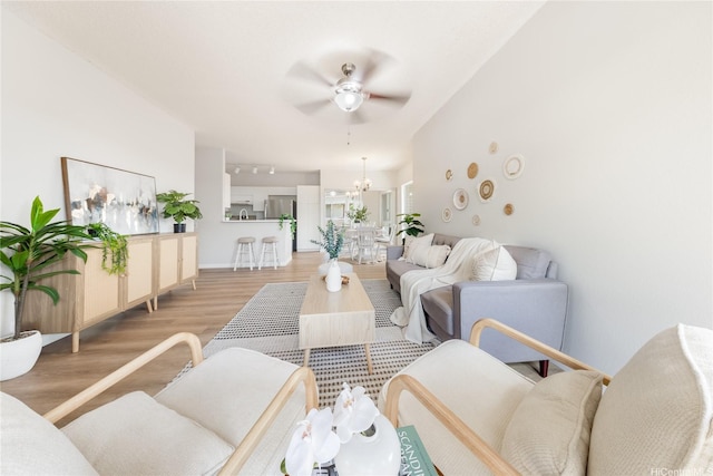 91-1059 Puaniu St Unit 21T, Ewa Beach, HI 96706 - living room with ceiling fan, light wood-style flooring, and a chandelier