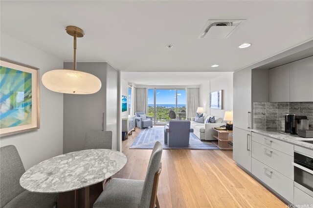383 Kalaimoku St Unit E1111, Honolulu, HI 96815 - dining area featuring light wood-type flooring and recessed lighting