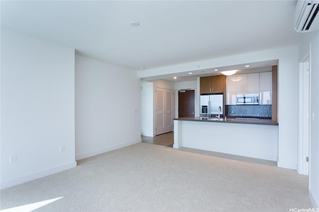 600 Ala Moana Blvd Unit 1907, Honolulu, HI 96813 - unfurnished living room with a wall mounted air conditioner, light carpet, recessed lighting, baseboards, and a sink