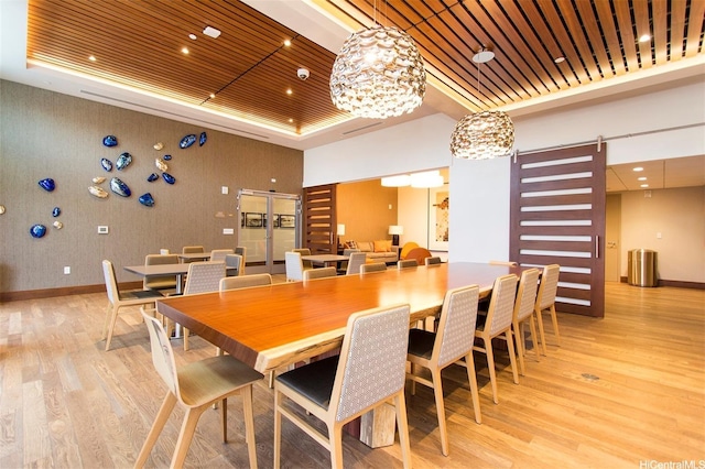 600 Ala Moana Blvd Unit 1907, Honolulu, HI 96813 - dining space featuring a raised ceiling, light wood-type flooring, baseboards, and wood ceiling