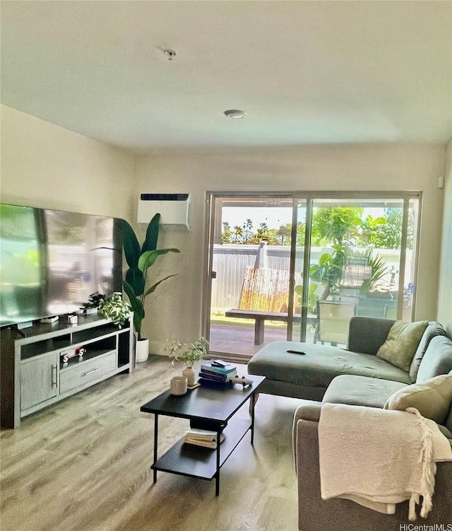91-1227 Kamaaha Ave Unit 302, Kapolei, HI 96707 - living room featuring plenty of natural light, wood finished floors, and a wall unit AC