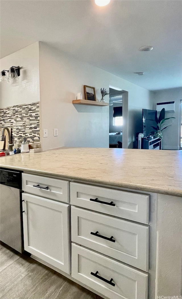 91-1227 Kamaaha Ave Unit 302, Kapolei, HI 96707 - kitchen with dishwasher, backsplash, light countertops, and white cabinets