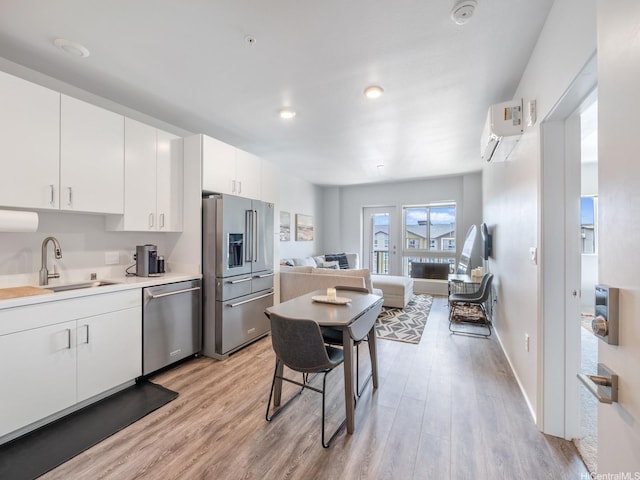 91-3641 Iwikuamoo St Unit 9408, Ewa Beach, HI 96706 - kitchen featuring appliances with stainless steel finishes, a sink, light wood-style floors, a wall mounted air conditioner, and recessed lighting