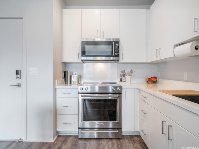 91-3641 Iwikuamoo St Unit 9408, Ewa Beach, HI 96706 - kitchen featuring stainless steel appliances, dark wood-type flooring, light countertops, and white cabinetry
