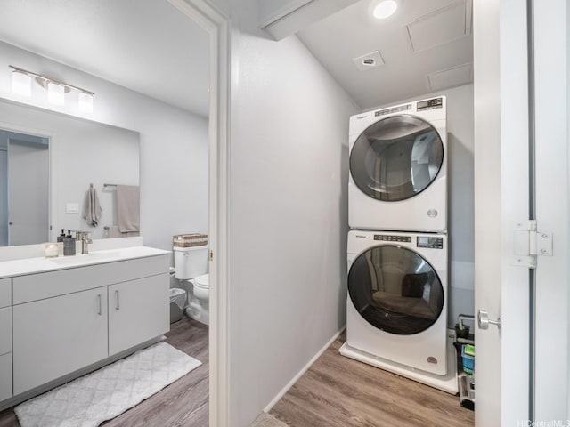 91-3641 Iwikuamoo St Unit 9408, Ewa Beach, HI 96706 - laundry area with stacked washer and clothes dryer, wood finished floors, and a sink