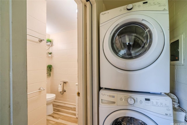95-024 Waihau St Unit 16A, Mililani, HI 96789 - laundry room featuring stacked washer / drying machine and wood finished floors