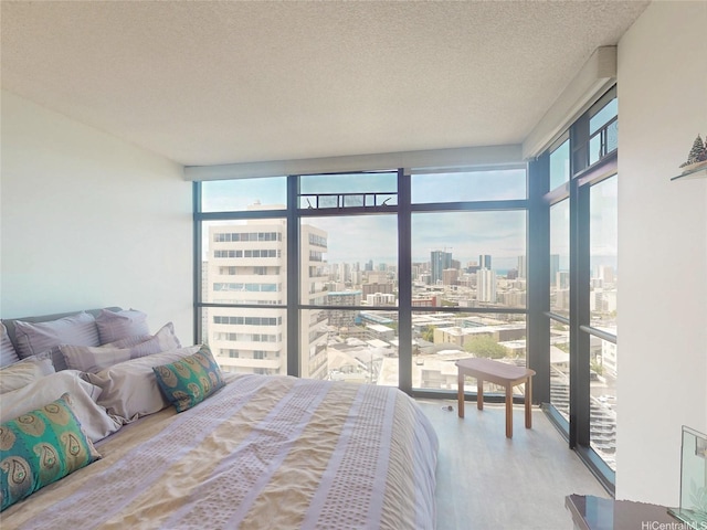 1015 Wilder Ave Unit 1003, Honolulu, HI 96822 - bedroom with a city view, wood finished floors, a textured ceiling, a wall of windows, and access to exterior