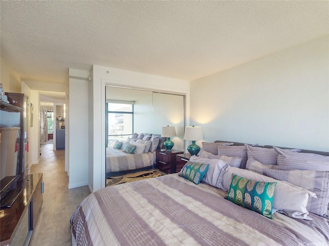 1015 Wilder Ave Unit 1003, Honolulu, HI 96822 - bedroom with a closet, a textured ceiling, and wood finished floors
