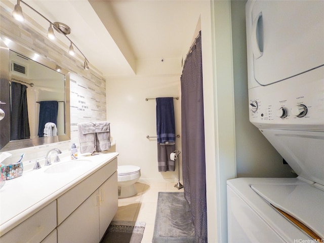 1015 Wilder Ave Unit 1003, Honolulu, HI 96822 - bathroom featuring estacked washer and dryer, toilet, tile patterned floors, and vanity