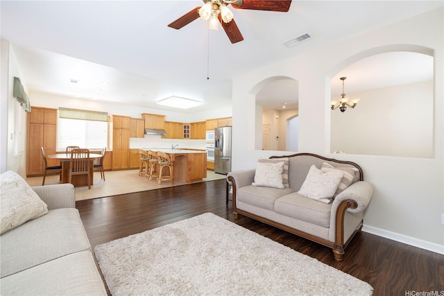 91-1104 Kaileonui St, Ewa Beach, HI 96706 - living area with arched walkways, wood finished floors, a ceiling fan, a chandelier, and baseboards