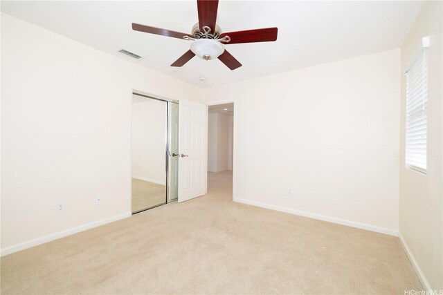 91-1104 Kaileonui St, Ewa Beach, HI 96706 - unfurnished bedroom with light carpet, a closet, baseboards, and ceiling fan
