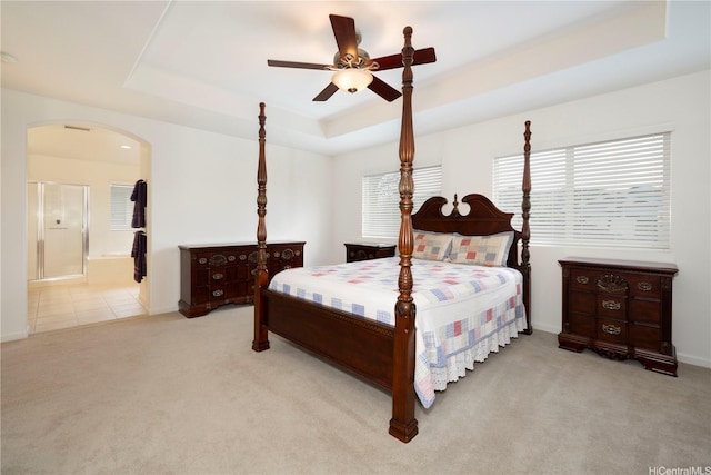 91-1104 Kaileonui St, Ewa Beach, HI 96706 - carpeted bedroom with arched walkways, a tray ceiling, ensuite bathroom, and baseboards