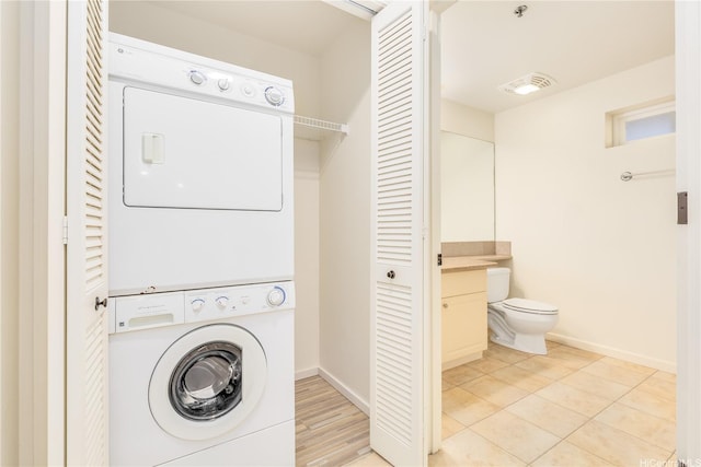 520 Lunalilo Home Rd Unit 7121, Honolulu, HI 96825 - washroom with stacked washing machine and dryer, baseboards, and light tile patterned floors