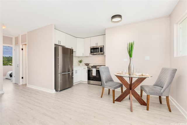 94-249 Waikele Rd Unit A205, Waipahu, HI 96797 - kitchen with stainless steel appliances, light wood-style flooring, plenty of natural light, and tasteful backsplash