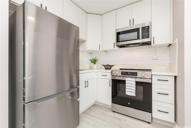 94-249 Waikele Rd Unit A205, Waipahu, HI 96797 - kitchen with stainless steel appliances, light countertops, white cabinetry, backsplash, and light wood-style floors