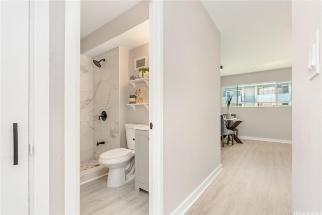 94-249 Waikele Rd Unit A205, Waipahu, HI 96797 - bathroom featuring a marble finish shower, wood finished floors, toilet, baseboards, and vanity
