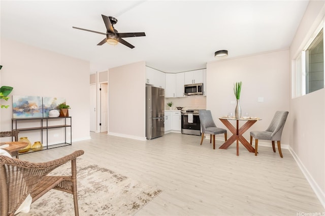 94-249 Waikele Rd Unit A205, Waipahu, HI 96797 - living room with light wood-style floors, ceiling fan, and baseboards