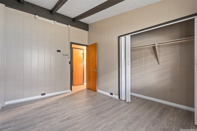 98-1225 Ulune St, Aiea, HI 96701 - unfurnished bedroom with wood finished floors, beamed ceiling, a closet, and baseboards
