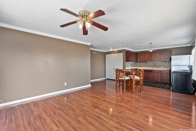 98-1225 Ulune St, Aiea, HI 96701 - kitchen featuring dark wood finished floors, a sink, ornamental molding, light countertops, and a ceiling fan