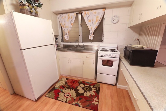 2626 Kuilei St Unit K, Honolulu, HI 96826 - kitchen with stainless steel counters, white appliances, a sink, light wood-style flooring, and tasteful backsplash